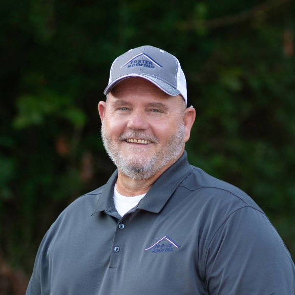 Headshot of Rick Shepherd of Foster Roofing outdoors wearing a baseball cap w Foster Roofing Logo