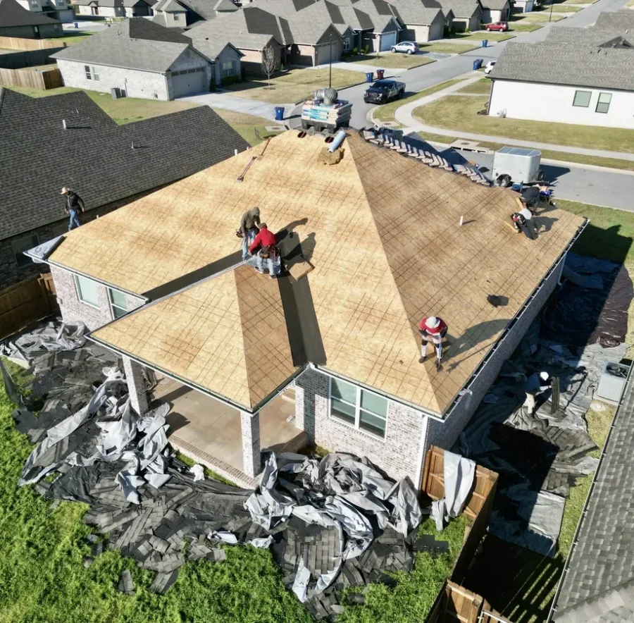 Foster Roofing crew installing a new roof over the decking during a roof replacement in Fort Smith, Arkansas