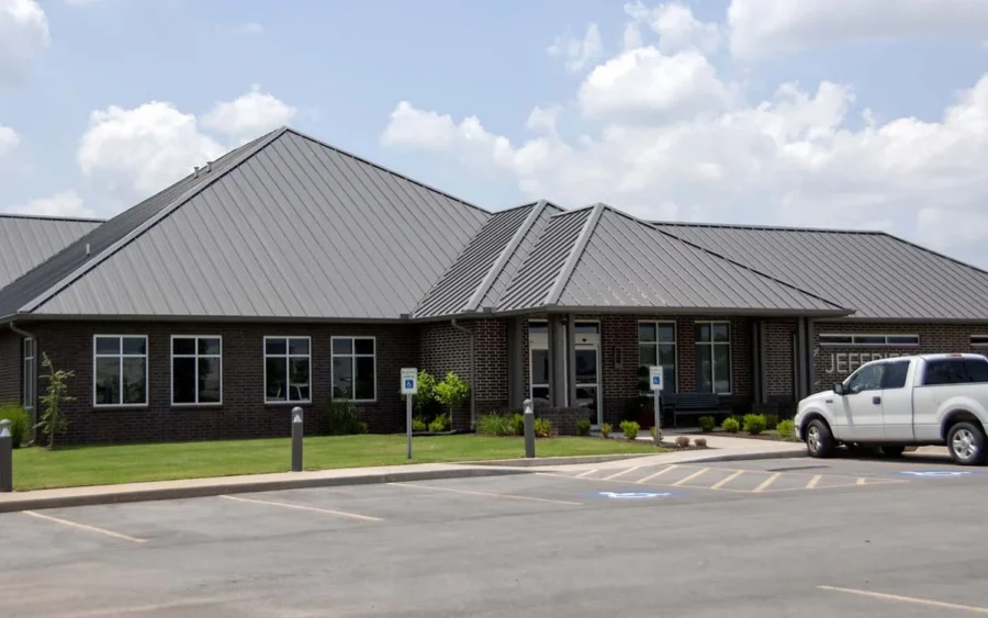 Gray metal roof on the Jeffries Eye Associates building in Rogers, Arkansas, a Foster Roofing commercial roofing project