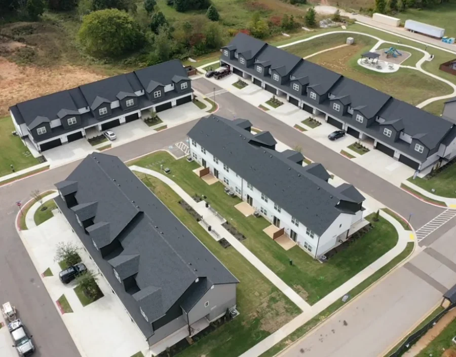 Aerial view of dark shingle roofs on new multifamily buildings in Siloam Springs, Arkansas, a Foster Roofing new construction roofing project