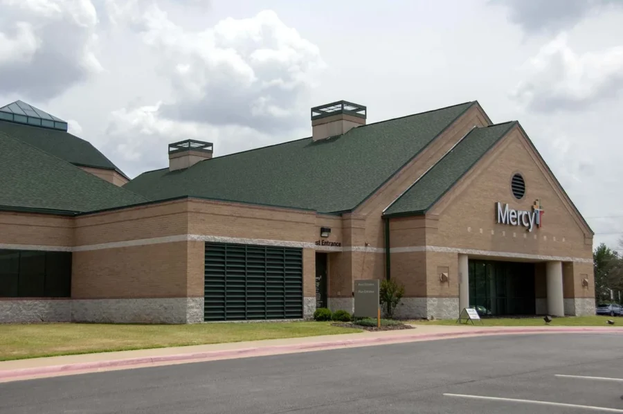 Green asphalt shingle roof on a brick commercial building, a Foster Roofing commercial roofing project